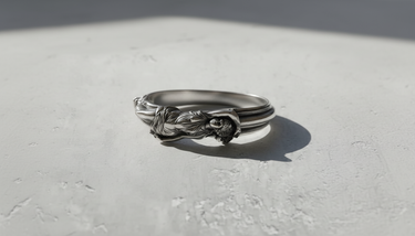 Close-up of the handcrafted silver goddess ring, showcasing the intricate flowing fabric and hair details.