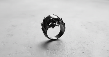 Black rhodium plated Silver Laurel Skull Ring shown at a three-quarter angle, highlighting the dark, polished finish.