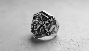 Angled view of the handcrafted Silver Blind Justice Ring, highlighting the deep oxidized finish and armored pauldron design.