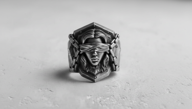 Front view of the Silver Blind Justice Ring, showcasing the blindfolded female face and chain details on a textured surface.