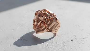 Rose gold plated Blind Justice Ring shown at an angle on a white textured surface, highlighting the detailed chains.
