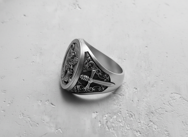 Side profile of the ornate Archangel Michael ring highlighting the handcrafted scrollwork and cross detail on the 925 silver band.