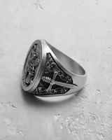Side view of the sterling silver Archangel Michael ring, detailing the ornate scrollwork and embossed cross on the band.
