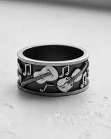 Oxidized 925 sterling silver music ring showcasing detailed guitar and violin instruments on a wide band.
