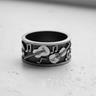 Oxidized sterling silver music ring with detailed guitar and violin design, showcasing the contrast and fine craftsmanship.