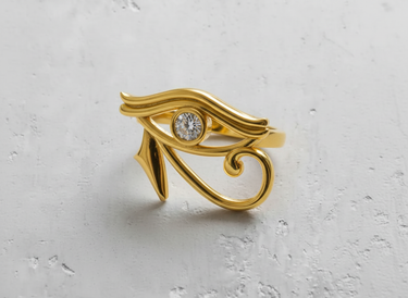 Gold-plated Eye of Horus ring showcasing the warm, polished finish of the stylized Egyptian eye design with a diamond.