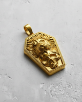 Gold vermeil coffin shaped pendant featuring a roaring lion and skull design on textured background