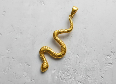 Gold-plated version of the serpentine snake pendant, showcasing the hexagonal scales with a bright, polished finish.