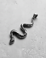 Angled view of the 925 sterling silver snake pendant, highlighting the detailed serpentine curve and polished finish.