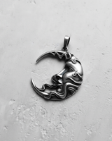 Angled side view of silver crescent moon pendant displaying thickness and bail loop