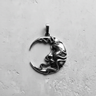 Detailed close-up of crescent moon face pendant showing intricate carving and serene expression