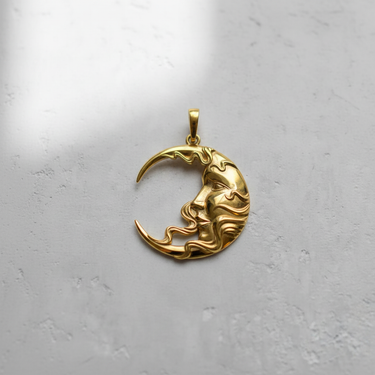 Gold vermeil crescent moon face pendant with flowing hair design on white background