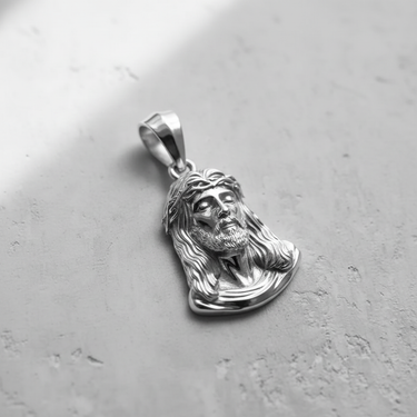 925 sterling silver Jesus head pendant featuring detailed crown of thorns and flowing hair design on textured background