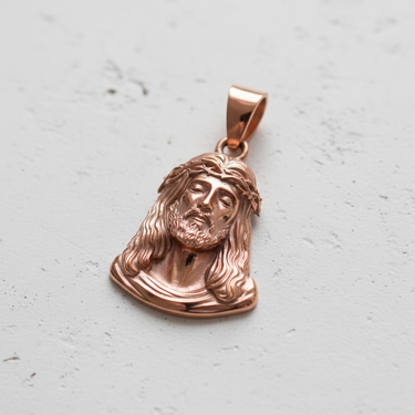 Rose gold plated silver Jesus head pendant with detailed crown of thorns and flowing hair design
