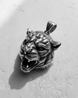 Side profile of silver tiger pendant highlighting 3D relief carving and oxidized finish for gothic jewelry style