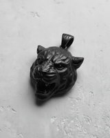 Black rhodium plated silver tiger pendant with a snarling expression, showcasing the dark, matte finish from a side angle.