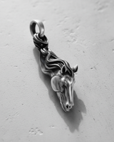 Close-up of a silver horse pendant in a black rhodium finish with polished highlights on the face, eye, and mane details.