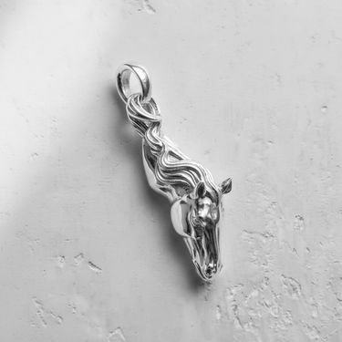Brightly polished 925 sterling silver horse pendant, showcasing the detailed sculptural lines of the horse head and mane-bail.