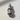 Close-up view of the handcrafted kettlebell hand pendant resting on a textured surface highlighting the silver finish