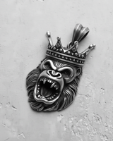 Silver King Gorilla Pendant with a roaring expression and detailed crown, shown from the front on a textured surface.