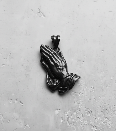 Close-up of the 925 sterling silver praying hands pendant, focusing on the realistic hand details and polished bail.