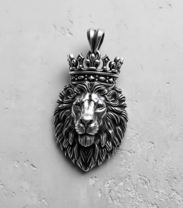 Detailed close-up of the oxidized silver lion head pendant with a royal crown, displayed on a textured white surface.