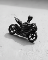 Black rhodium plated sterling silver sport bike pendant side view on white background