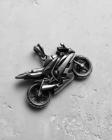 Close-up of the detailed sportbike pendant in oxidized silver, capturing the aerodynamic fairings from a slight top angle.