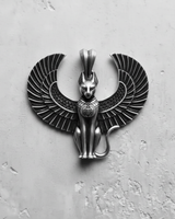 Top-down view of the silver Egyptian Cat Pendant showing the full spread of the detailed, feathered wings on a textured surface.