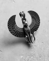 Close-up of the handcrafted silver Bastet pendant, focusing on the headdress and scarab collar detail on the cat figure.