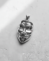Close-up of the handcrafted Silver Guy Fawkes pendant, detailing the stylized smile and mustache on polished 925 silver.