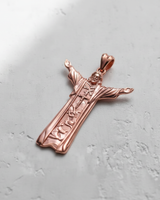 Rose gold plated silver Jesus pendant with outstretched arms, showcasing detailed religious symbols on a light background.