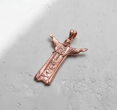 Rose gold plated silver Jesus pendant with outstretched arms, showcasing detailed religious symbols on a light background.