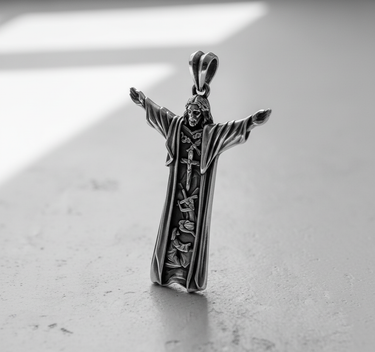 Oxidized 925 sterling silver Jesus pendant shown from the front, highlighting the intricate Christian carvings on the robe.