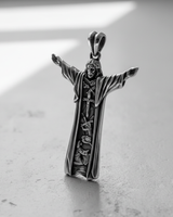 Angled view of the 925 sterling silver Jesus Christ pendant, highlighting the polished finish and intricate carvings with dramatic lighting.