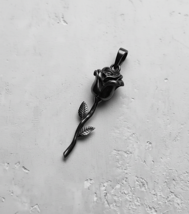 Black rhodium plated silver rose pendant shown from above, highlighting its dark, romantic aesthetic on a white surface.