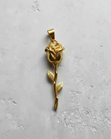 14K gold vermeil silver rose pendant with a long stem and two leaves, shown against a light textured background.