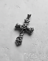 Silver rose cross pendant with an oxidized finish, showcasing the central rose and vine details on a light gray background.
