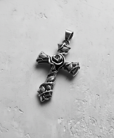 Silver rose cross pendant with an oxidized finish, showcasing the central rose and vine details on a light gray background.