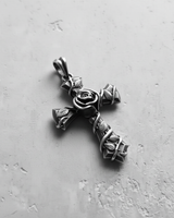 Angled view of the 925 sterling silver rose cross pendant, highlighting the three-dimensional vine and leaf craftsmanship.