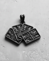 Top-down close-up of the handcrafted Silver Four Kings Pendant, showcasing the deep engravings and craftsmanship of the piece.