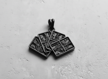 Top-down close-up of the handcrafted Silver Four Kings Pendant, showcasing the deep engravings and craftsmanship of the piece.
