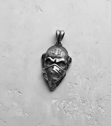 Front view of the handcrafted 925 sterling Silver Monkey Pendant, showcasing the furrowed brow and symmetrical star pattern on the mask.