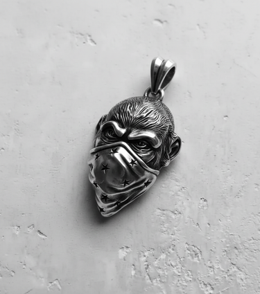 Angled view of the oxidized 925 sterling Silver Monkey Pendant, highlighting the deep shadows and intricate details of the bandana.