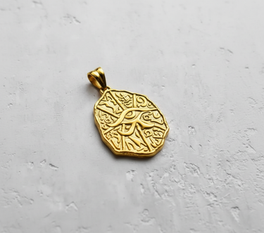 Front view of 14K gold vermeil Egyptian Eye pendant with textured hieroglyphic background and Eye of Horus symbol