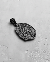 Side angle shot of the Silver Eye of Horus Pendant, revealing its thickness and the polished bail on a light gray background.