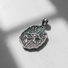 Angled view of 925 sterling silver Egyptian Eye pendant featuring ancient coin design and oxidized finish