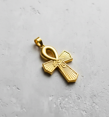 Luxury 18k gold plated Egyptian Ankh pendant with a modern stepped-edge cross design, displayed on a concrete slab.
