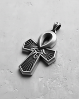 925 sterling silver Ankh pendant showing the oxidized finish that highlights the carved Eye of Horus and sunbeam details.