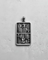 Silver Jack pendant with an oxidized finish, showing the detailed mirrored playing card design on a textured white surface.